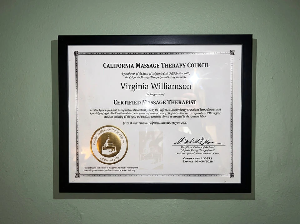 Framed certificate bearing the name Virginia Williamson on a sage-green wall in Nia’s former San Francisco studio